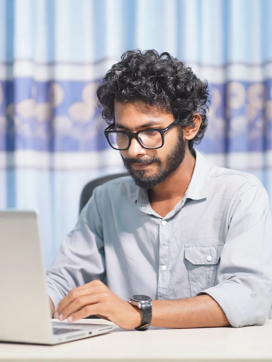 Web designer at his laptop building an online store